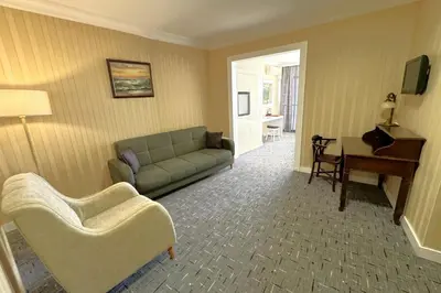 a living room with a couch and a piano at Tekirdağ Yat Hotel in Tekirdag