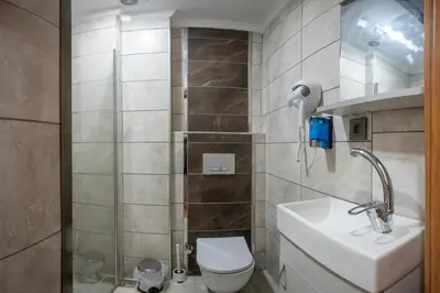 a bathroom with a shower with a toilet and a sink at Taxim Sunpera Suites in Istanbul