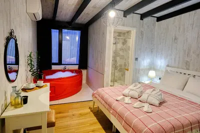 a bedroom with a red tub and a bed at World DREAMS Sapanca in Sakarya