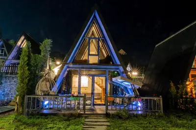 a house with a pointed roof at night at World DREAMS Sapanca in Sakarya