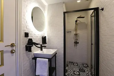 a bathroom with a sink and a shower at Taksim Istiklal Street Kamilbey Hotel in Istanbul