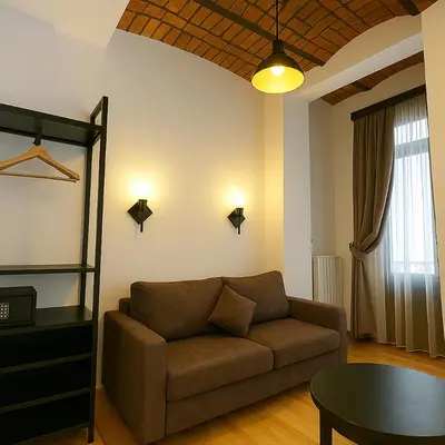 a living room with a couch and a table at Taksim Istiklal Street Kamilbey Hotel in Istanbul
