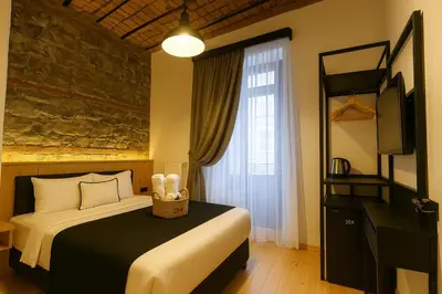 a hotel room with a bed and a window at Taksim Istiklal Street Kamilbey Hotel in Istanbul