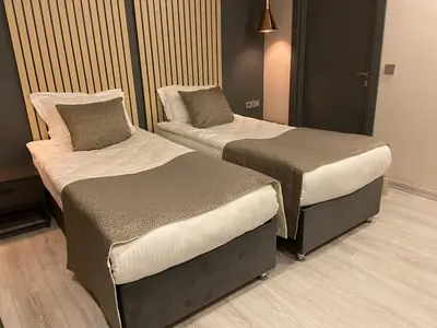 two beds in a hotel room with at Antik Houses in Istanbul