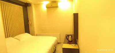 a small room with a bed and a phone at Antik Houses in Istanbul