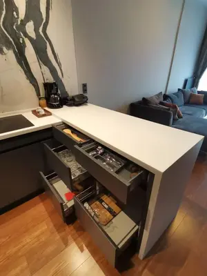 a kitchen with a white counter with an open drawer at BENESTA BEYOGLU in Istanbul
