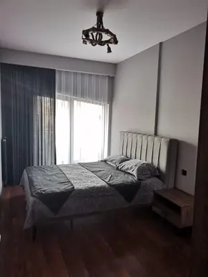 a bedroom with a bed with a chandelier and a window at BENESTA BEYOGLU in Istanbul