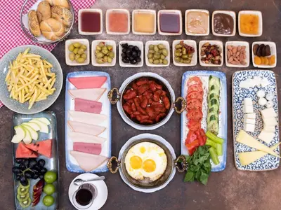 a table with many different types of food on it at İzz Hotel Koşuyolu in Istanbul