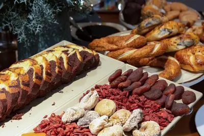 a buffet of different types of bread and pastries at İzz Hotel Koşuyolu in Istanbul