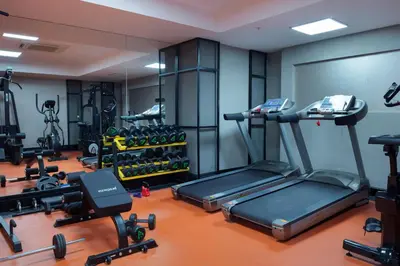 a gym with a treadmill and a lot of exercise equipment at İzz Hotel Koşuyolu in Istanbul