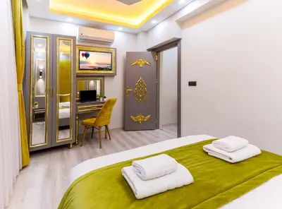 a bedroom with a large bed with two towels on it at Santa Rio Taxim in Istanbul