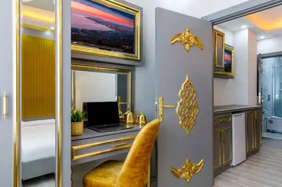 a bedroom with a desk with a laptop on it at Santa Rio Taxim in Istanbul