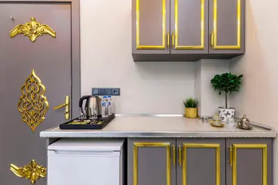 a kitchen with yellow cabinets and a sink at Santa Rio Taxim in Istanbul