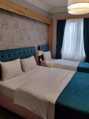 a hotel room with two beds and a window at Miss City Hotel Taksim in Istanbul