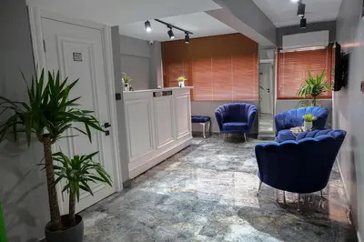 a meeting room with blue chairs and plants at Kassimo Hotel in Istanbul