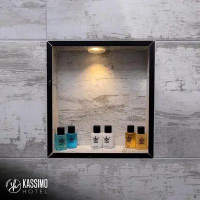 a shelf with four different colored bottles on it at Kassimo Hotel in Istanbul