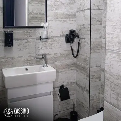 a bathroom with a sink and a shower at Kassimo Hotel in Istanbul