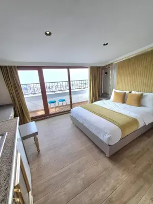 a bedroom with a large bed and a large window at Taksim La Marino Hotel in Istanbul