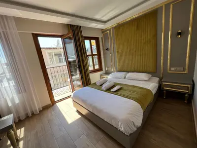 a bedroom with a bed and a large window at Taksim La Marino Hotel in Istanbul
