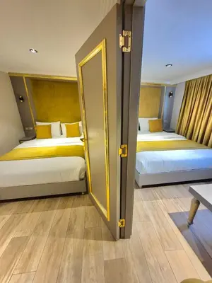 a hotel room with two beds and a door at Taksim La Marino Hotel in Istanbul