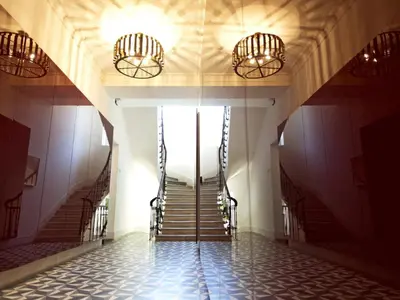 a hallway with stairs in a building with lights at Casa Di Bava Suites by TCH in Istanbul