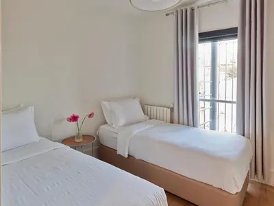 two beds in a room with a window at Casa Di Bava Suites by TCH in Istanbul