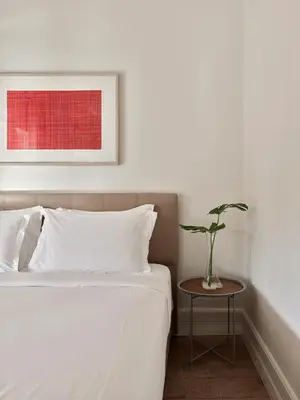 a bedroom with a bed and a table with a vase on it at Casa Di Bava Suites by TCH in Istanbul