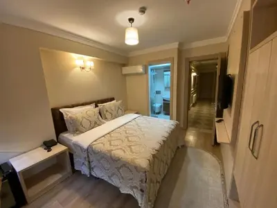 a bedroom with a bed and a television in it at Hotel Mavirem in Istanbul