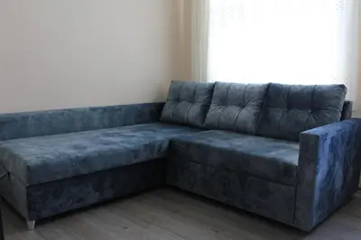 a blue couch in a room with a window at Carvan HOTEL in Istanbul
