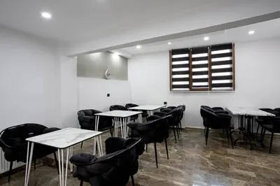 a room with tables and chairs and a window at Carvan HOTEL in Istanbul