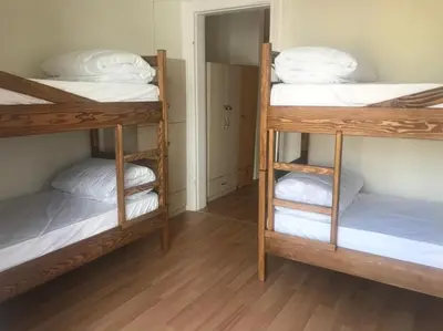 a room with three bunk beds with white pillows at Kalkedon Plus in Istanbul