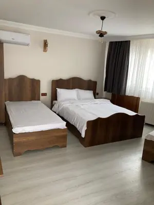 a bedroom with two beds with white sheets at Ulusoy Old Cıty in Istanbul