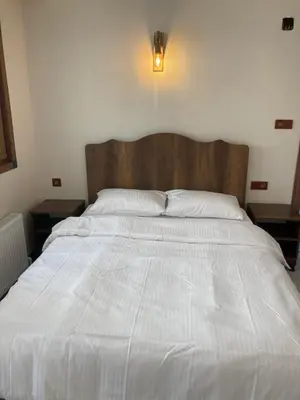 a large white bed in a bedroom with two tables at Ulusoy Old Cıty in Istanbul