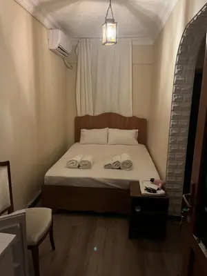 a bedroom with a bed with two towels on it at Ulusoy Old Cıty in Istanbul