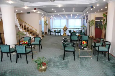 a banquet hall with tables and chairs and stairs at Avlonya Hotel in Istanbul