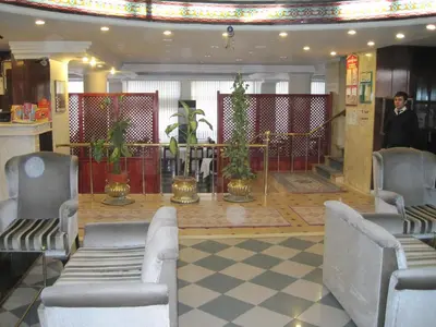 a lobby of a hotel with chairs and plants at Avlonya Hotel in Istanbul