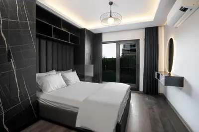 a bedroom with a white bed and a black wall at Andalus Villas NO ALCOHOL ALLOWED with Heated Pool in Sapanca