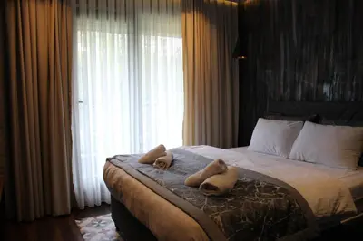 two teddy bears on a bed in a bedroom at Adess Otel in Çekmeköy
