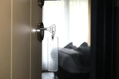 a tag is hanging on a door with a window at Adess Otel in Çekmeköy