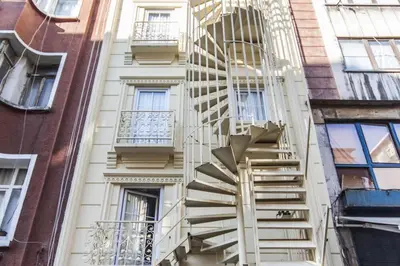 a spiral fire escape on the side of a building at Ottoman Time Hotel in Istanbul