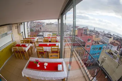 a balcony with tables and chairs and a view of a city at Ottoman Time Hotel in Istanbul