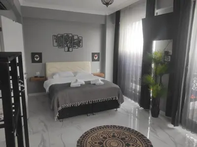 a bedroom with a large bed and a large window at family villas 2 in Sapanca