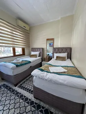 a bedroom with two beds in a room at Apart La Mia in Istanbul
