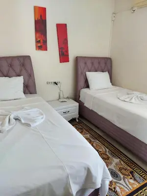 two beds sitting next to each other in a room at Apart La Mia in Istanbul