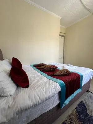 a bed with red pillows on it in a room at Apart La Mia in Istanbul