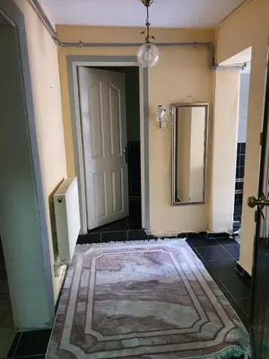 a hallway with a rug and a door with a mirror at Apart La Mia in Istanbul
