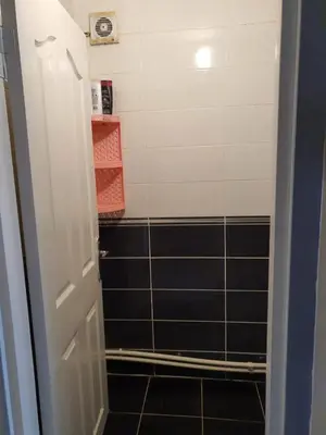 a bathroom with a shower with black tile at Apart La Mia in Istanbul