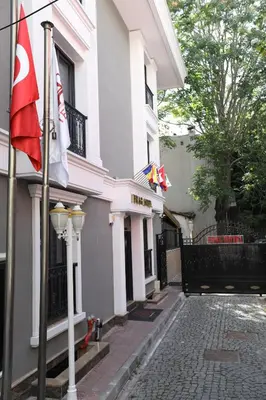 a building with two flags and a street light at PRAG HOTEL in Istanbul