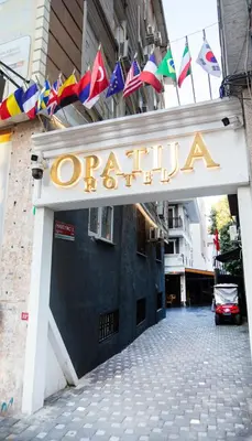 a sign that saysocracia on a building with flags at Opatija Hotel in Istanbul