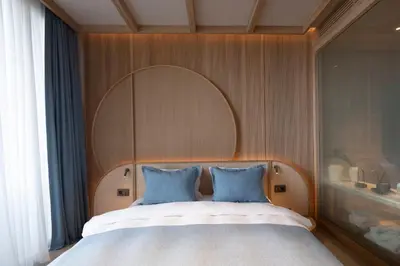 a bedroom with a large bed with blue pillows at İnemare Hotel in Demirköy